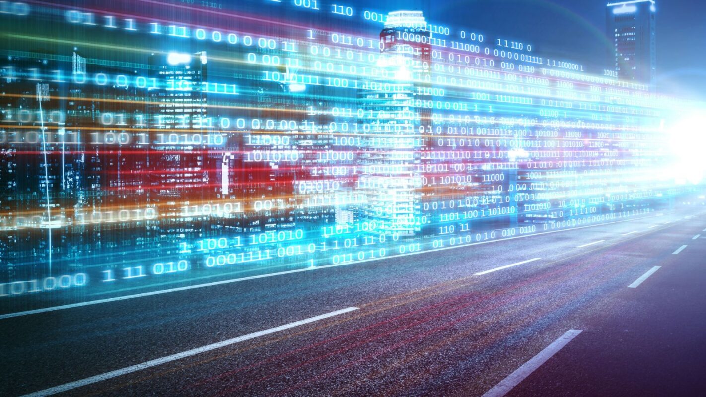 Digital data stream over a highway with motion blur, illustrating AI traffic management and automated workflows